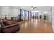 Expansive living room with hardwood floors, modern furnishings, and natural light from large windows at 7721 Roma Dune Dr, Wesley Chapel, FL 33545
