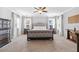 Spacious main bedroom featuring carpet floors, recessed lights, decorative sconces, and a large, upholstered bed at 7721 Roma Dune Dr, Wesley Chapel, FL 33545