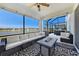 Enclosed lanai with comfortable seating area and outdoor fire pit overlooking the lake at 7721 Roma Dune Dr, Wesley Chapel, FL 33545