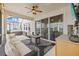 Covered patio with comfortable seating, fire pit, and outdoor bar area at 7721 Roma Dune Dr, Wesley Chapel, FL 33545