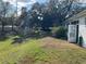Spacious backyard with a gentle slope, mature trees, and access to the home through a glass-paneled door at 8019 Brien Green Way, Temple Terrace, FL 33637