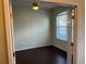 Bright bedroom featuring wood floors, a ceiling fan, and large windows for natural light at 8019 Brien Green Way, Temple Terrace, FL 33637