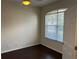 Well-lit room with wood floors, a ceiling fan, and natural light from the large window at 8019 Brien Green Way, Temple Terrace, FL 33637