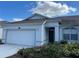 Well-maintained single-Gathering home with a two-car garage and manicured front yard at 8019 Brien Green Way, Temple Terrace, FL 33637