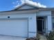 Inviting exterior view of home with fresh paint, two car garage, and lush landscaping at 8019 Brien Green Way, Temple Terrace, FL 33637