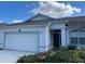 Charming one-story home featuring a two-car garage and a freshly sealed driveway at 8019 Brien Green Way, Temple Terrace, FL 33637