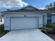 Single story home featuring a spacious two car garage and freshly sealed driveway at 8019 Brien Green Way, Temple Terrace, FL 33637