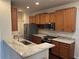 Modern kitchen featuring stainless steel appliances, granite countertops, and wood cabinets at 8019 Brien Green Way, Temple Terrace, FL 33637