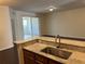 Open kitchen with granite countertops, stainless steel sink, and view into living area at 8019 Brien Green Way, Temple Terrace, FL 33637