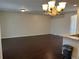Open concept living and dining area with wood floors and elegant chandelier at 8019 Brien Green Way, Temple Terrace, FL 33637