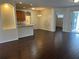 Open-concept living space featuring wood floors, a breakfast bar, and seamless flow to the kitchen at 8019 Brien Green Way, Temple Terrace, FL 33637