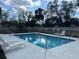 Sparkling community pool with lounge chairs, providing a relaxing and refreshing outdoor amenity for residents at 8019 Brien Green Way, Temple Terrace, FL 33637