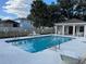 Community pool with clear blue water, surrounded by lounge chairs, and a nearby pool house at 8019 Brien Green Way, Temple Terrace, FL 33637