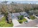 Aerial view of property showcasing manicured lawns, mature trees, and convenient two-car garages at 887 Lucas Ln, Oldsmar, FL 34677