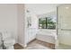 Bright bathroom with a large soaking tub, walk-in shower and white cabinets at 887 Lucas Ln, Oldsmar, FL 34677