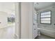 Bathroom and bedroom showing tiled shower/bath at 887 Lucas Ln, Oldsmar, FL 34677