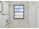 Bathroom featuring tiled shower/bath with grab bar at 887 Lucas Ln, Oldsmar, FL 34677