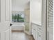 Bright bathroom with a large soaking tub, walk-in shower and white cabinets at 887 Lucas Ln, Oldsmar, FL 34677