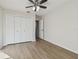 Bright bedroom featuring hardwood floors, ceiling fan, and a closet with bi-fold doors at 887 Lucas Ln, Oldsmar, FL 34677