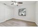 Bedroom featuring wood-look flooring, ceiling fan, and closet at 887 Lucas Ln, Oldsmar, FL 34677