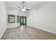 Bedroom featuring wood look floors, ceiling fan, and black trimmed windows at 887 Lucas Ln, Oldsmar, FL 34677