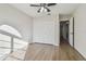 Bright bedroom featuring wood-look floors and ceiling fan at 887 Lucas Ln, Oldsmar, FL 34677