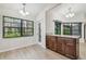 Dining area with wood cabinets, granite countertops, and a large window with views at 887 Lucas Ln, Oldsmar, FL 34677