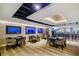 Modern dining area with a bar, multiple TVs, neutral colors, and contemporary furnishings at 887 Lucas Ln, Oldsmar, FL 34677