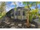 Charming exterior view of the home with mature landscaping and stone pathway at 887 Lucas Ln, Oldsmar, FL 34677