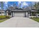 Charming single-story home with a two-car garage, landscaped yard, and inviting curb appeal at 887 Lucas Ln, Oldsmar, FL 34677