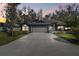 Charming single-story home with a two-car garage, landscaped yard, and inviting curb appeal at 887 Lucas Ln, Oldsmar, FL 34677