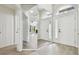 Inviting foyer with hardwood floors and a large mirror reflecting the open floor plan at 887 Lucas Ln, Oldsmar, FL 34677