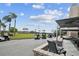 View of the golf cart parking area near the patio of the community clubhouse at 887 Lucas Ln, Oldsmar, FL 34677