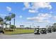 View of the golf course with a fleet of golf carts parked nearby under a cloudy sky at 887 Lucas Ln, Oldsmar, FL 34677