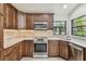 Kitchen with stainless appliances, tile backsplash, and granite countertops at 887 Lucas Ln, Oldsmar, FL 34677