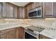 Kitchen with stainless steel appliances and granite countertops at 887 Lucas Ln, Oldsmar, FL 34677