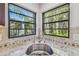 Kitchen sink with tile backsplash and black trimmed windows at 887 Lucas Ln, Oldsmar, FL 34677