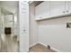 A laundry room with white cabinets, washer and dryer hookups and a view of the kitchen at 887 Lucas Ln, Oldsmar, FL 34677