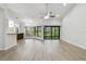 Bright living room with new flooring, ceiling fan, and expansive windows with nature views at 887 Lucas Ln, Oldsmar, FL 34677