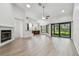 Open-concept living room featuring hardwood floors, a fireplace, and natural light from sliding doors at 887 Lucas Ln, Oldsmar, FL 34677