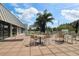 View of outdoor patio with several tables, chairs, and umbrellas for residents at 887 Lucas Ln, Oldsmar, FL 34677