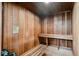Interior view of a wood-paneled sauna room with a bench and a warning sign at 887 Lucas Ln, Oldsmar, FL 34677