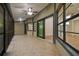 Screened-in porch featuring tile flooring, a ceiling fan, and access to the interior at 887 Lucas Ln, Oldsmar, FL 34677