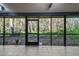 Spacious screened porch with tiled floor provides views of natural wooded setting at 887 Lucas Ln, Oldsmar, FL 34677