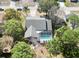 Aerial view of home with screened in pool and mature trees at 8979 Hernando Way, Weeki Wachee, FL 34613