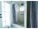 Bathroom with white fixtures, a walk-in shower, and seaside decor creates a refreshing space at 8979 Hernando Way, Weeki Wachee, FL 34613