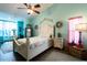 Bright bedroom boasts coastal decor, ceiling fan, and light hardwood floors at 8979 Hernando Way, Weeki Wachee, FL 34613