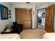 Bedroom featuring a wicker chair, closet, and light blue paint at 8979 Hernando Way, Weeki Wachee, FL 34613