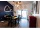 Charming dining area with stylish table set, contrasting dark wall, and sliding door access to patio at 8979 Hernando Way, Weeki Wachee, FL 34613