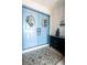 Welcoming entryway with double doors, wreaths, a patterned rug, and a decorative dresser at 8979 Hernando Way, Weeki Wachee, FL 34613